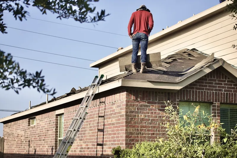 Professional roofer working on a residential roof in Hubbard
